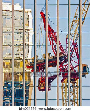 Stock Photograph - Distorted Reflection of a Tower Crane. Fotosearch
