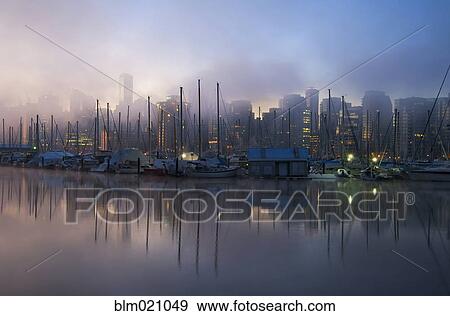 Stock Photo - Early morning view over the marina and waterfront and mist rising . Fotosearch