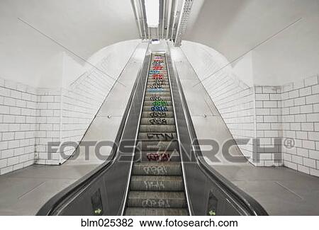 Stock Image - Escalator down to an underground Metro Station in Paris. Fotosearch