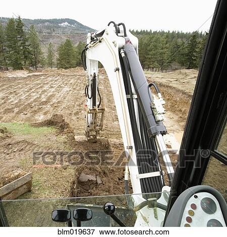 Excavator at a Construction Site View Large Photo Image Stock Photo - Excavator at a Construction Site. Fotosearch
