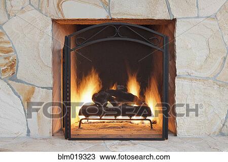 Stock Image - Fireplace and hearth in outdoor living space. Fotosearch