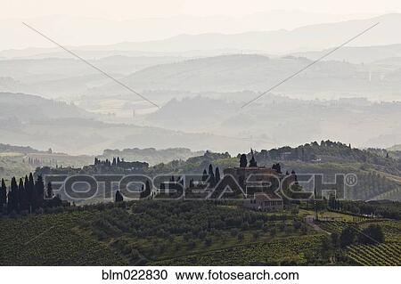 Stock Image - Foggy Tuscan Landscape at Sunrise. Fotosearch