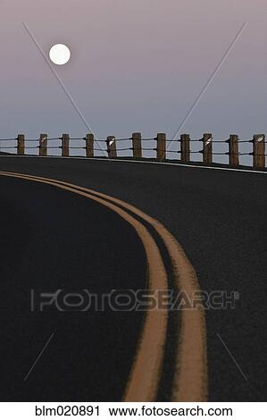 Stock Image - Full Moon Over a Curving Road. Fotosearch