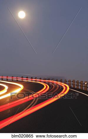 Stock Photography - Full Moon Over a Curving Road. Fotosearch