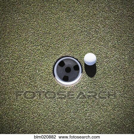 Golf Ball Next to a Putting Cup View Large Photo Image Stock Image - Golf Ball Next to a Putting Cup. Fotosearch