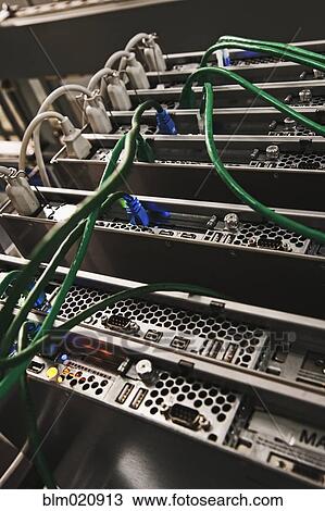 Stock Image - Green Cables Connected to the Back of a Server. Fotosearch