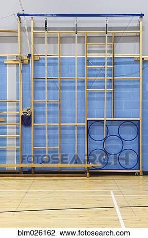 Gymnasium equipment folded away at the side of the sports hall of a modern secondary school View Large Photo Image Stock Image - Gymnasium equipment folded away at the side of the sports hall of a modern secondary school. Fotosearch