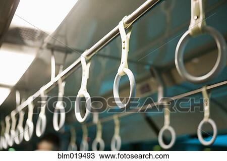 Stock Image - Handles on Mass Transit Vehicle. Fotosearch