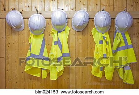 Stock Image - Hard hats and safety vests with reflective stripes. Fotosearch