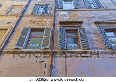 Historic building with blue shutters View Large Photo Image Stock Photograph - Historic building with blue shutters. Fotosearch