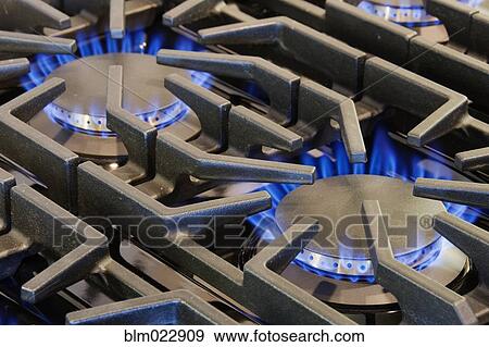 Stock Photo - Ignited Gas Burning on Commercial Stove. Fotosearch