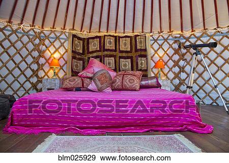King size bed with bright colors, pillows and telescope inside a Mongolian Yurt, Andalucia, Spain View Large Photo Image Stock Photo - King size bed with bright colors, pillows and telescope inside a Mongolian Yurt, Andalucia, Spain. Fotosearch