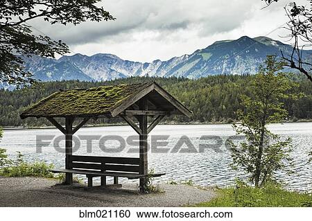 Stock Image - Lakeside Sitting Area and Mountains. Fotosearch