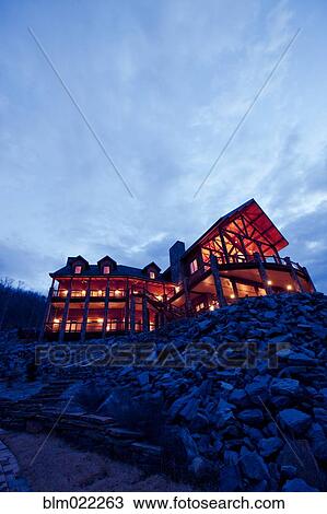Stock Image - Large Wooden Hotel at Night. Fotosearch