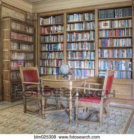 Library with table and chairs for conversation, bookcases and reading lamp View Large Photo Image Stock Photo - Library with table and chairs for conversation, bookcases and reading lamp. Fotosearch