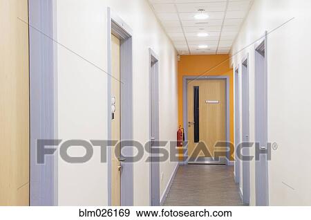 Looking down a corridor in a modern secondary View Large Photo Image Stock Photo - Looking down a corridor in a modern secondary . Fotosearch