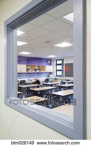 Looking through a window from the corridor into a classroom of a modern secondary school View Large Photo Image Stock Photo - Looking through a window from the corridor into a classroom of a modern secondary school. Fotosearch