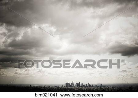 Stock Image - Los Angeles Skyline Beneath Cloudy Sky. Fotosearch