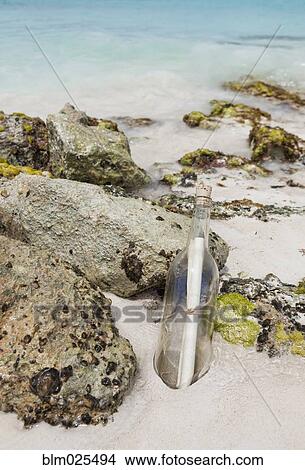 Note in bottle washed up on shore View Large Photo Image Picture - Note in bottle washed up on shore. Fotosearch