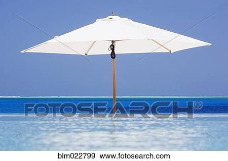 Stock Photo - Open Beach Umbrella in Water. Fotosearch