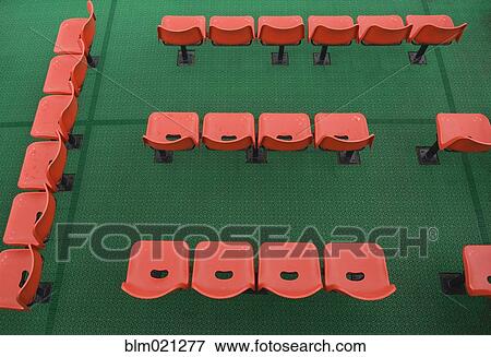 Stock Photo - Orange Chairs On Green Carpet. Fotosearch