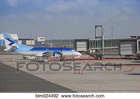 Stock Image - Parked Airplane at an Airport Gate. Fotosearch