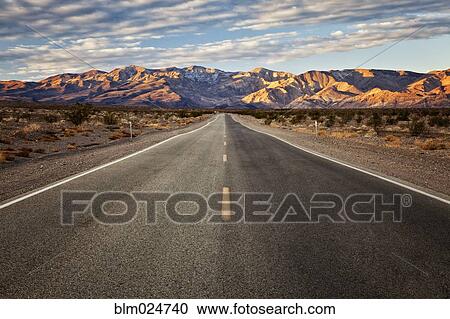 Stock Image - Paved road in Death Valley National Park. Fotosearch