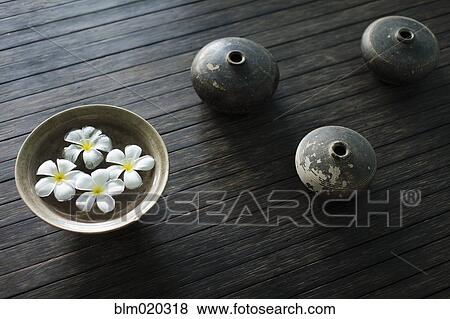 Petals of the orchid flower in a bowl of water View Large Photo Image Stock Photo - Petals of the orchid flower in a bowl of water. Fotosearch