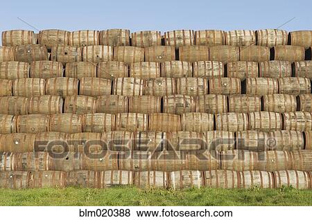 Pile of whisky barrels outside a warehouse View Large Photo Image Stock Photo - Pile of whisky barrels outside a warehouse. Fotosearch