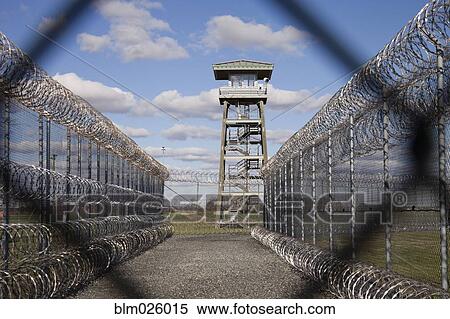 Prison fence, watch tower and barbed wire at Correctional Facility View Large Photo Image Stock Photography - Prison fence, watch tower and barbed wire at Correctional Facility. Fotosearch
