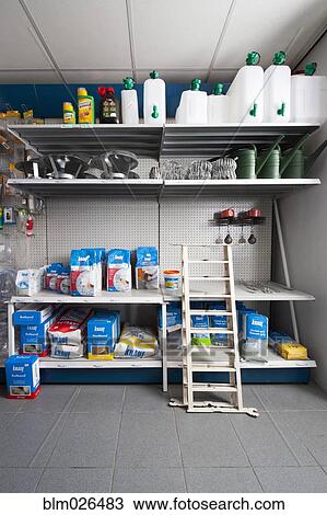 Stock Image - Rack with gardening and building supplies at a hardware store. Fotosearch