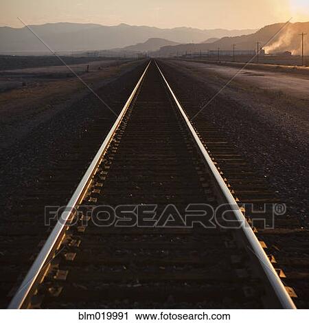 Stock Image - Railroad tracks at dusk. Fotosearch