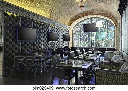 Restaurant interior with TV screens on leather covered wall View Large Photo Image Stock Photo - Restaurant interior with TV screens on leather covered wall. Fotosearch