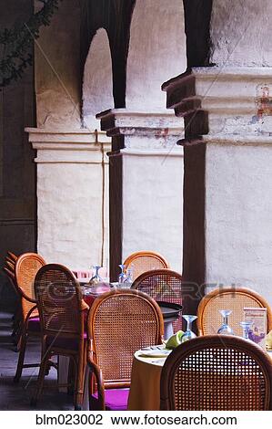 Stock Image - Restaurant Seating Amidst Columns. Fotosearch
