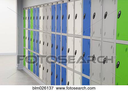 Row of green, blue and grey lockers in the corridor of a modern secondary school View Large Photo Image Stock Photo - Row of green, blue and grey lockers in the corridor of a modern secondary school. Fotosearch