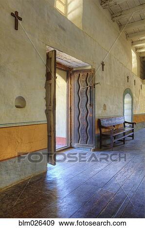 Stock Photo - Sanctuary Door, hardwood floors, stations of the cross, thick adobe brick walls. Fotosearch