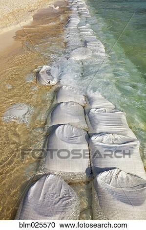 Sandbags at waters edge to prevent the erosion  View Large Photo Image Stock Image - Sandbags at waters edge to prevent the erosion . Fotosearch