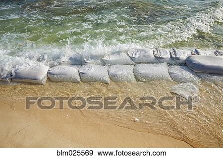 Sandbags at waters edge to prevent the erosion  View Large Photo Image Stock Photo - Sandbags at waters edge to prevent the erosion . Fotosearch