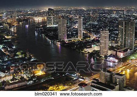 skyscrapers illuminated against the evening sky View Large Photo Image Stock Image - skyscrapers illuminated against the evening sky. Fotosearch
