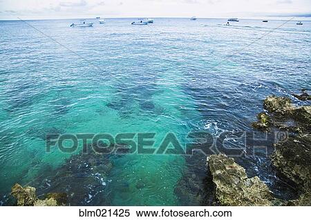 Stock Photography - Small Boats Off a Tropical Coast. Fotosearch