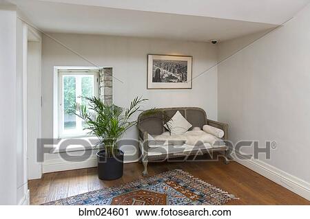 Stock Image - Small Sofa in a Sparse Room. Fotosearch