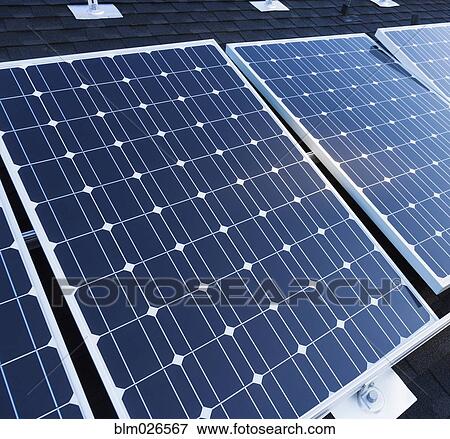 Solar panels fixed on the rooftop of a house View Large Photo Image Stock Photo - Solar panels fixed on the rooftop of a house . Fotosearch