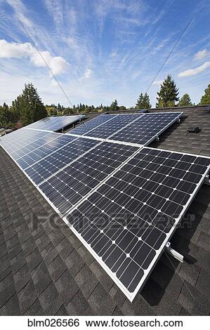 Stock Photograph - Solar panels fixed on the rooftop of a house . Fotosearch