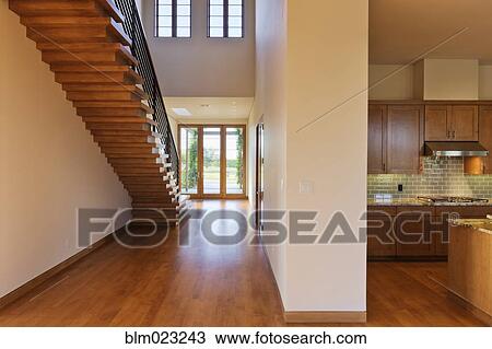 Spacious Hallway Showing a Staircase and Modern Kitchen View Large Photo Image Stock Image - Spacious Hallway Showing a Staircase and Modern Kitchen. Fotosearch