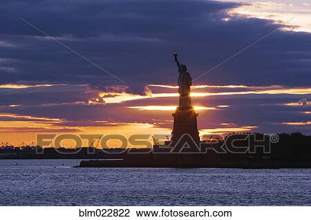Stock Image - Statue of Liberty at Sunset. Fotosearch