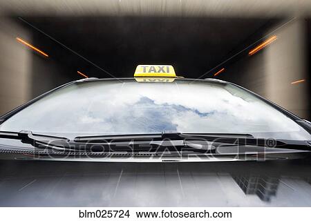 Taxi cab emerging from a tunnel View Large Photo Image Picture - Taxi cab emerging from a tunnel. Fotosearch