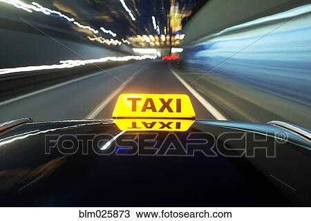 Taxi driving over a motorway at night View Large Photo Image Stock Image - Taxi driving over a motorway at night. Fotosearch