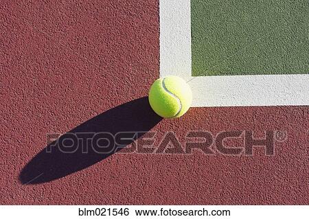 Stock Photograph - Tennis Ball Sitting on Edge of Tennis Court. Fotosearch
