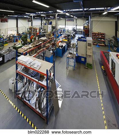 The factory floor of an industrial coiled spring factory View Large Photo Image Stock Photo - The factory floor of an industrial coiled spring factory. Fotosearch