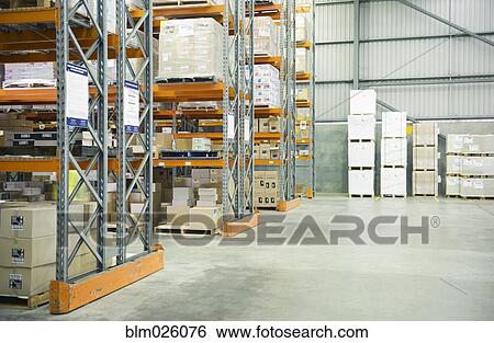 Stock Photograph - The interior of a tidy organized warehouse, with shelves stacked. Fotosearch